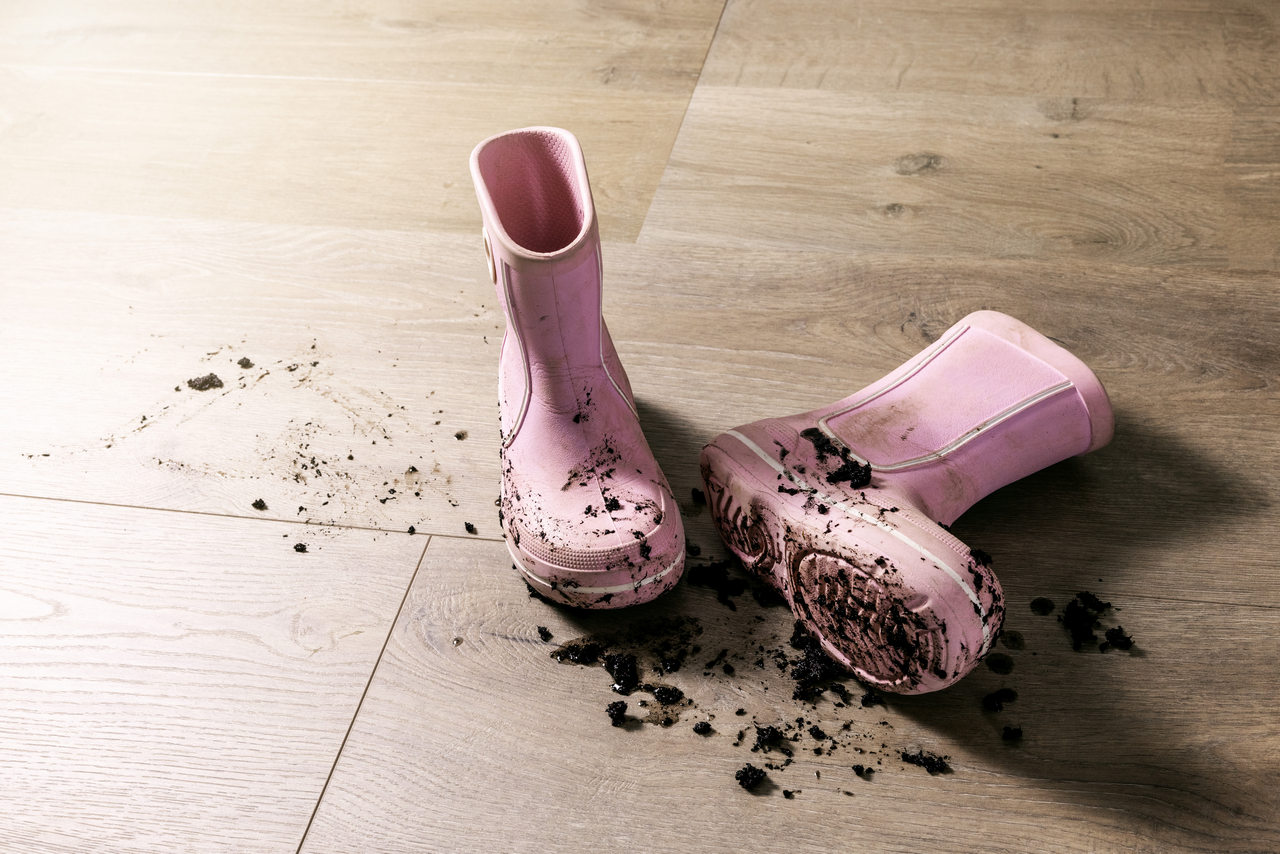 Shoes worn indoors can damage wooden floor finishes through abrasion